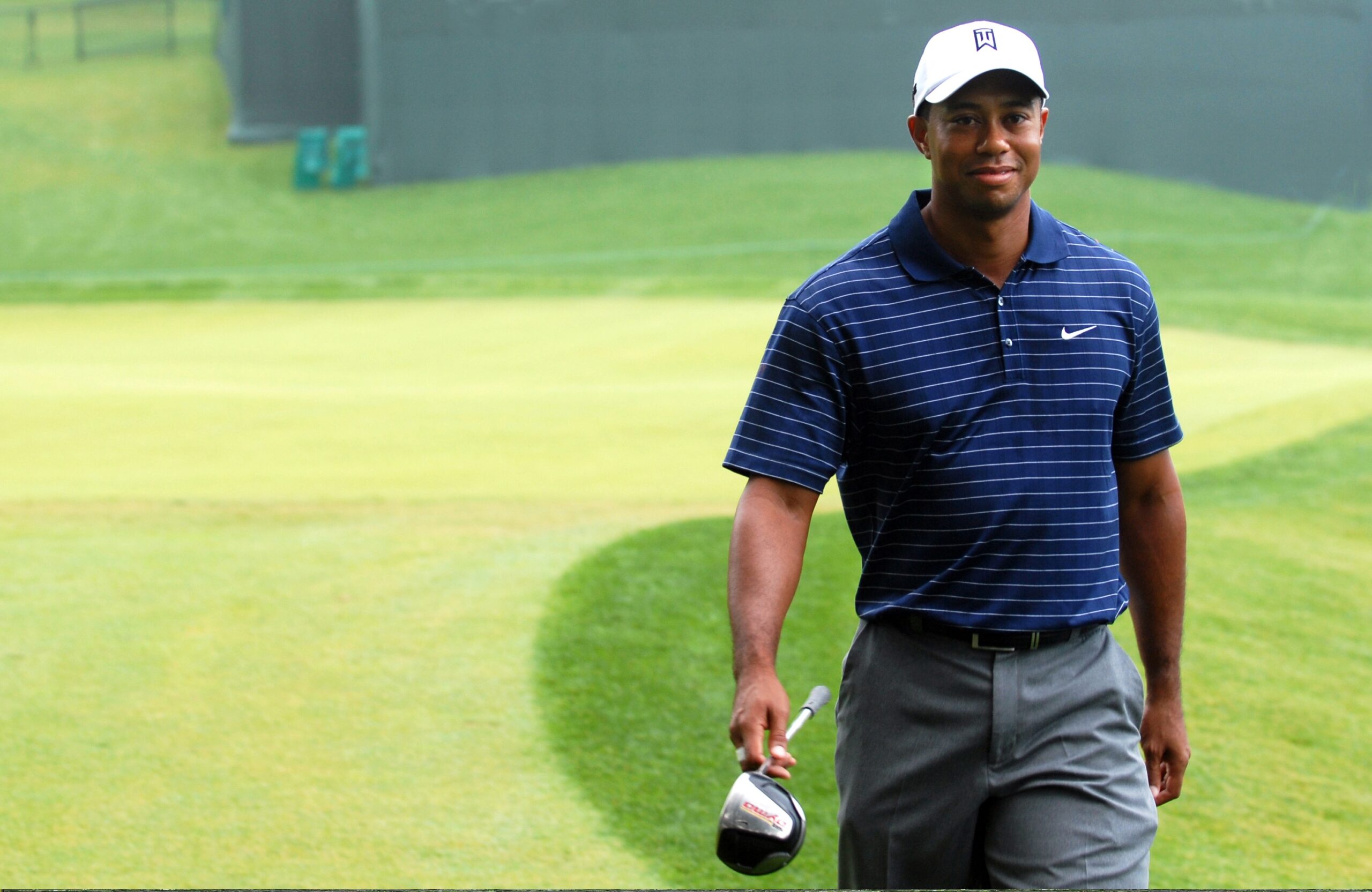 Tiger Woods smiling on a golf course in 2009