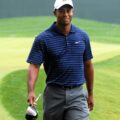 Tiger Woods smiling on a golf course in 2009