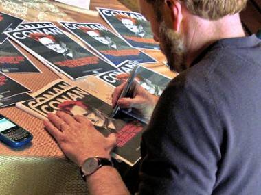 Conan O'Brien signs documentary posters 