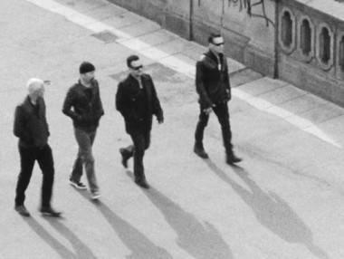 U2 band members walking black and white photo