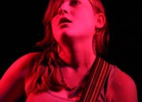 Lauren O'Connell playing guitar