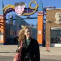 Nellie McKay standing outside of an amusement park