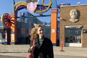 Nellie McKay standing outside of an amusement park